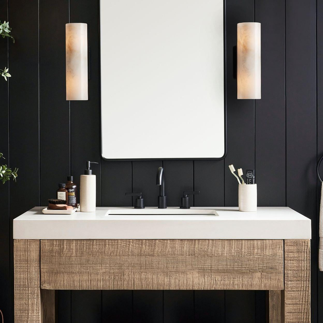 Doran tube sconce demonstrating its elongated alabaster form