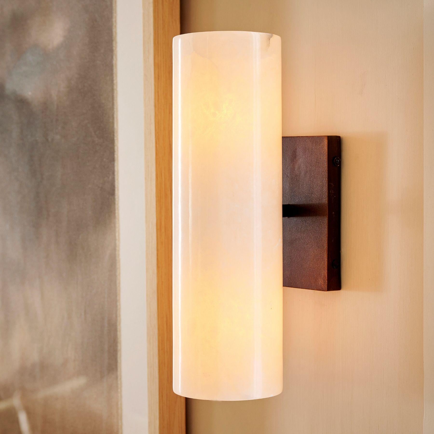 Close view of the Doran alabaster shade and metal wall plate